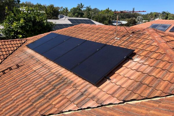 Black solar panels installed on a tiled roof on the Gold Coast