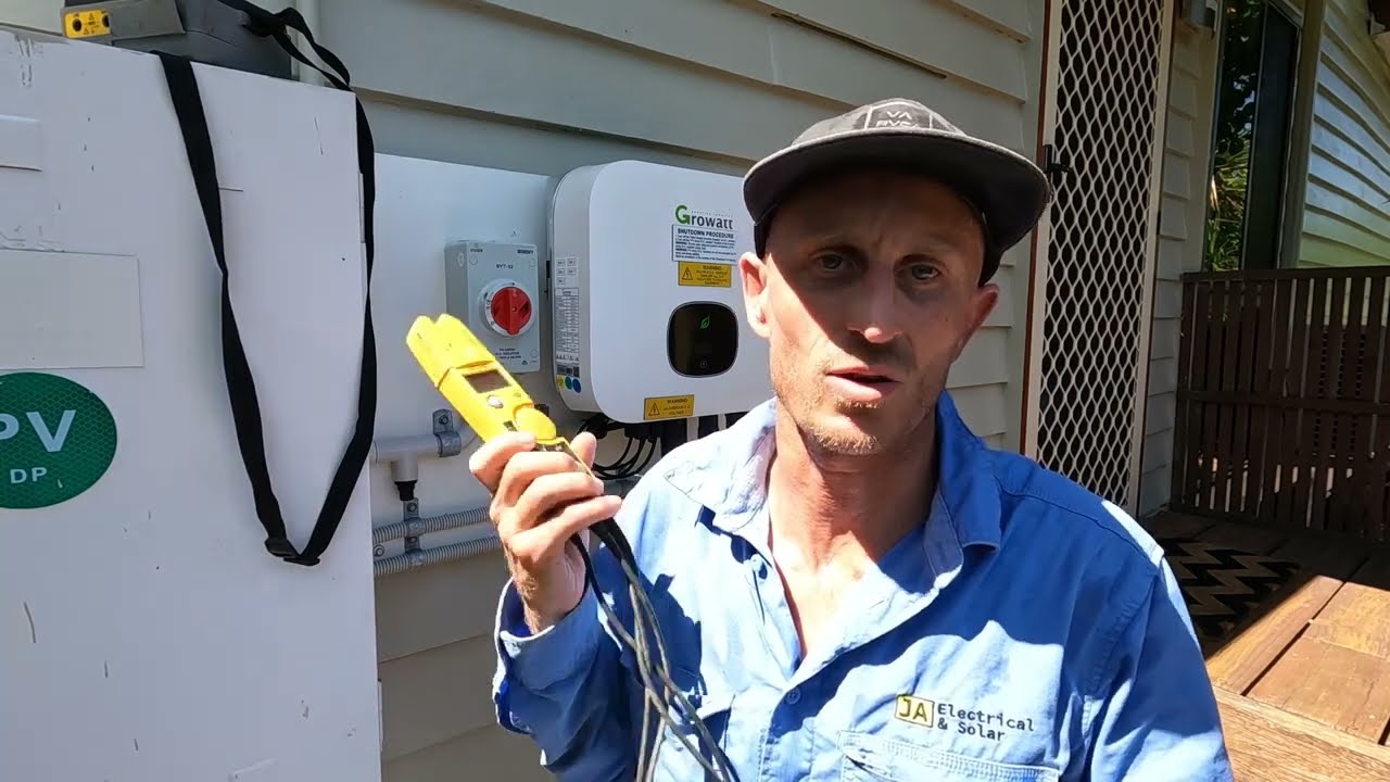 Jeremy from JA Electrical & Solar using a clamp meter to test a solar inverter during fault finding