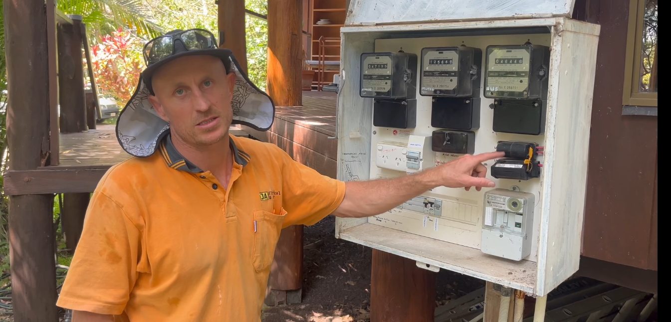 Jeremy Alderson from JA Electrical & Solar inspecting the meter box and service mains